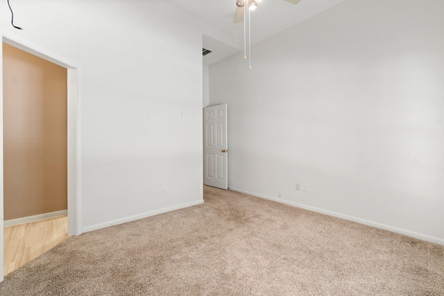 empty room featuring light colored carpet and ceiling fan