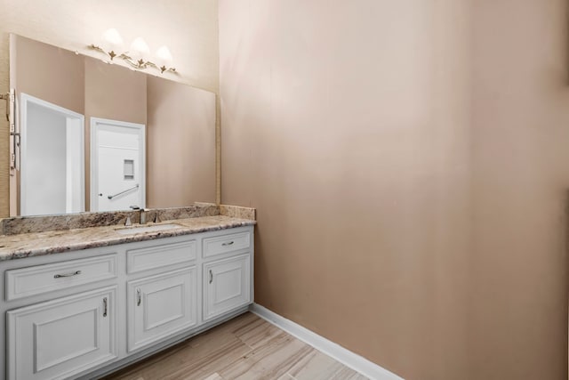 bathroom featuring hardwood / wood-style flooring and vanity