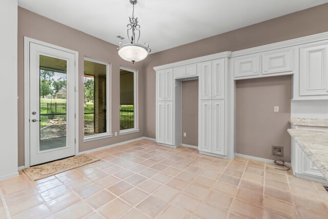 unfurnished dining area with light tile patterned floors