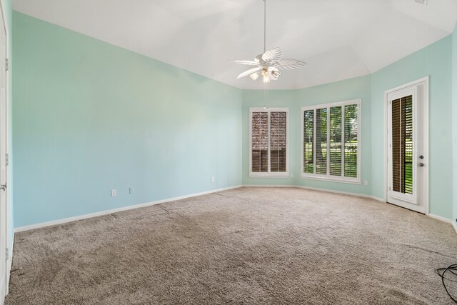 empty room featuring carpet, ceiling fan, and lofted ceiling