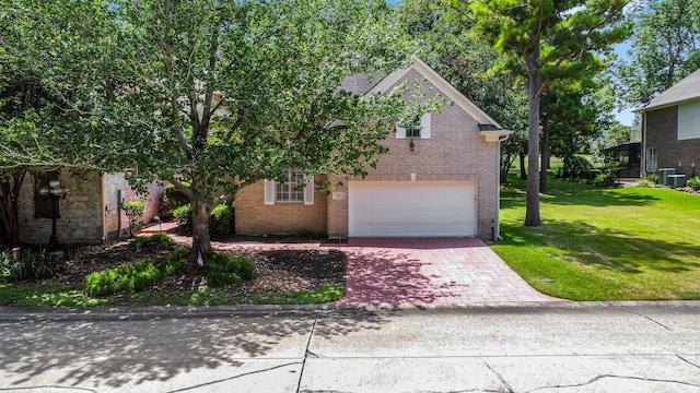 view of front of house with cooling unit, a garage, and a front lawn