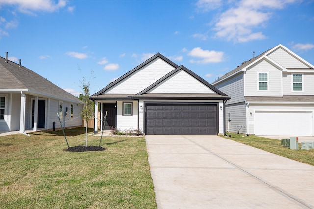 view of front of home with a front yard and a garage