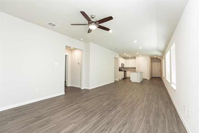 unfurnished living room featuring hardwood / wood-style flooring and ceiling fan