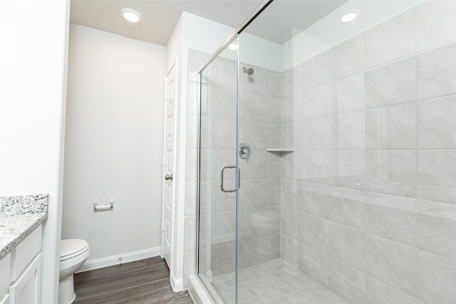 bathroom with vanity, toilet, and a shower with shower door