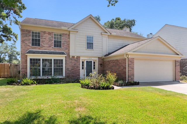 view of front of home with a garage and a front lawn