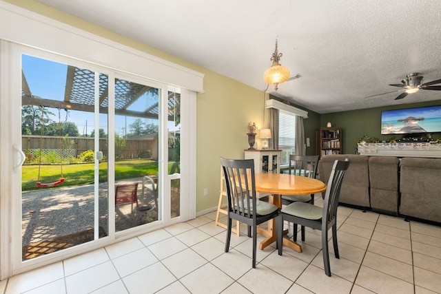 dining room featuring plenty of natural light, ceiling fan, and light tile patterned flooring