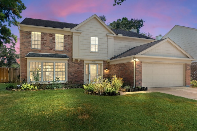 view of front facade with a lawn and a garage