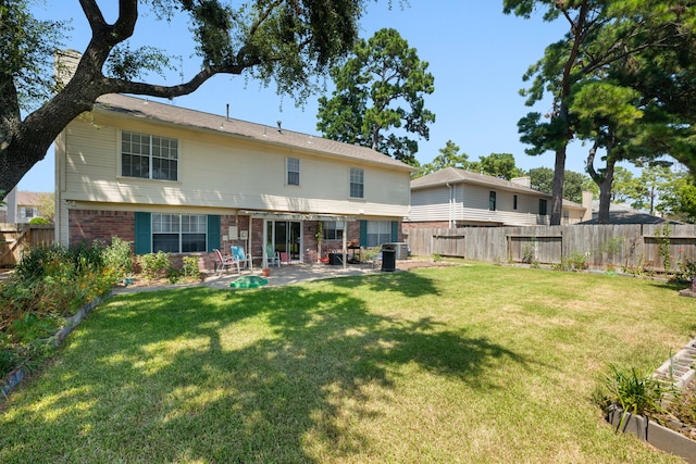 back of property with a patio area and a yard