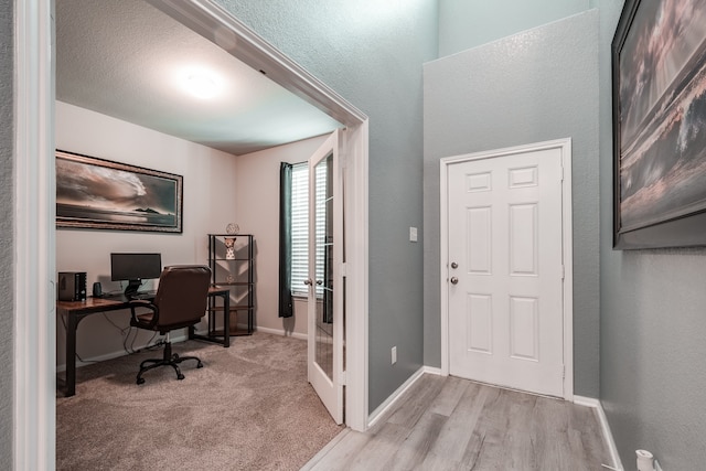 carpeted office with a textured ceiling