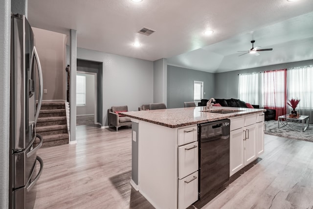 kitchen featuring dishwasher, sink, stainless steel fridge with ice dispenser, a center island with sink, and white cabinets