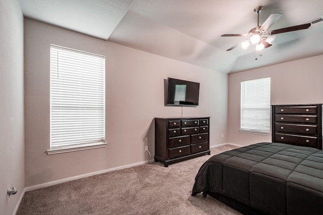 carpeted bedroom with ceiling fan and lofted ceiling