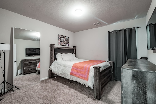 bedroom with carpet flooring and a textured ceiling