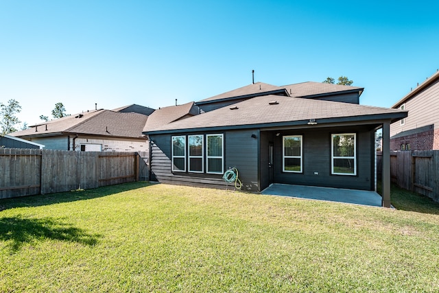 back of house with a lawn and a patio area