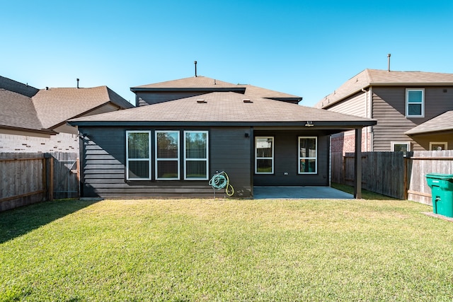 rear view of house featuring a patio area and a yard