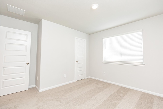 empty room with light colored carpet