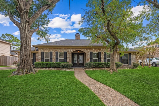 ranch-style house featuring french doors and a front yard