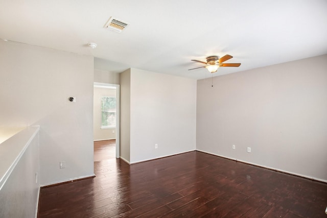 unfurnished room featuring visible vents, ceiling fan, baseboards, and wood finished floors