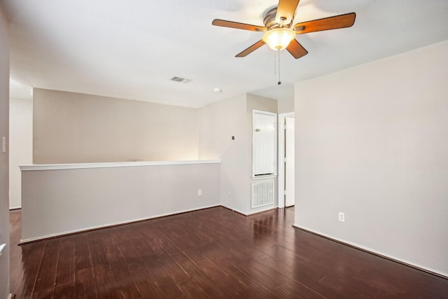 unfurnished room with baseboards, wood finished floors, visible vents, and a ceiling fan