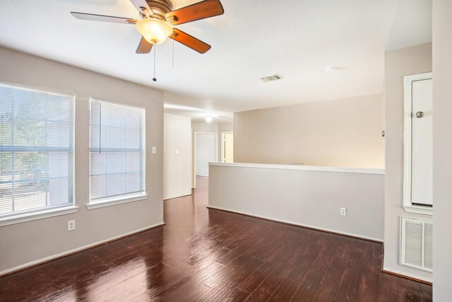 unfurnished room with visible vents, ceiling fan, baseboards, and wood finished floors