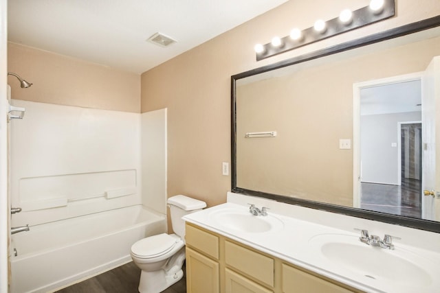 full bath featuring visible vents, a sink, toilet, and double vanity