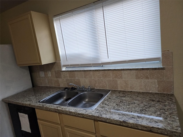 kitchen featuring tasteful backsplash and a sink