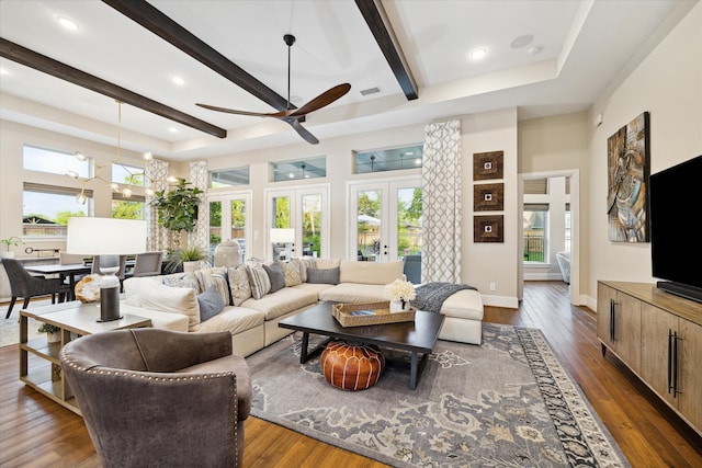 living room with dark hardwood / wood-style flooring, french doors, beamed ceiling, and ceiling fan with notable chandelier