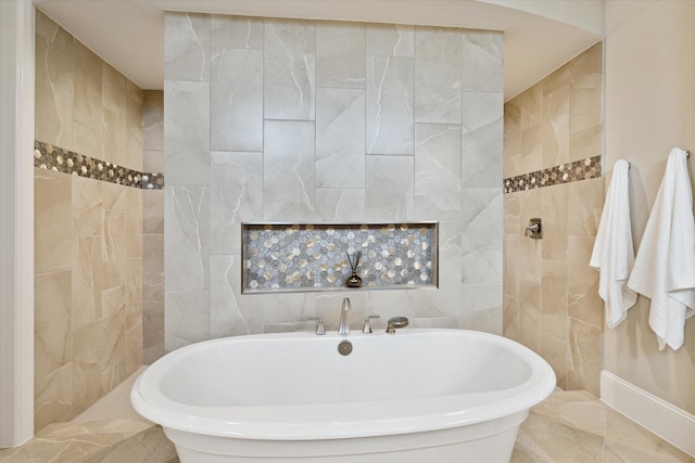 bathroom featuring a bathtub and tile walls