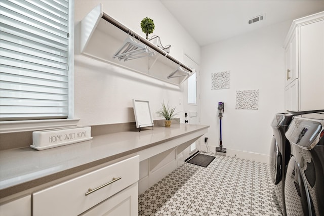 clothes washing area featuring cabinets and independent washer and dryer