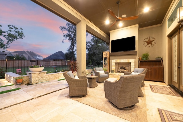 view of patio featuring ceiling fan and an outdoor fireplace