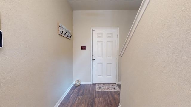 doorway to outside with dark wood-type flooring