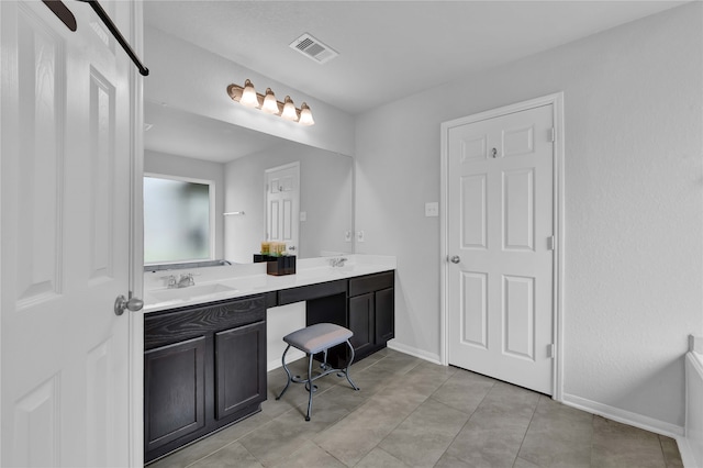 bathroom with tile patterned flooring and vanity