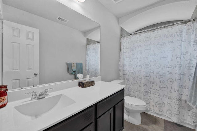 bathroom featuring toilet, vanity, tile patterned floors, and walk in shower