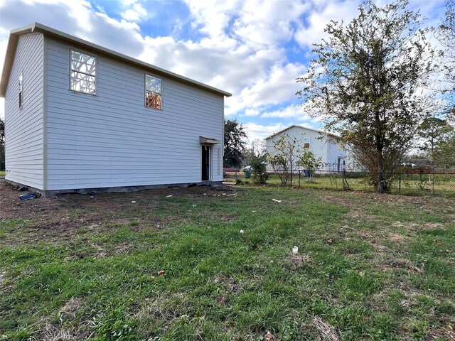 view of property exterior featuring a lawn