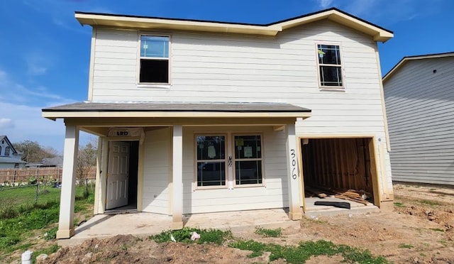 view of front facade featuring a garage and fence