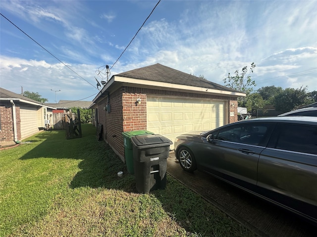 view of side of home with a garage and a yard