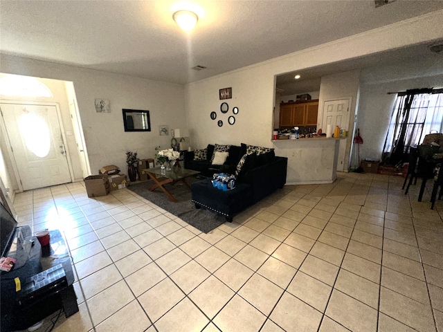 tiled living room with crown molding and a textured ceiling