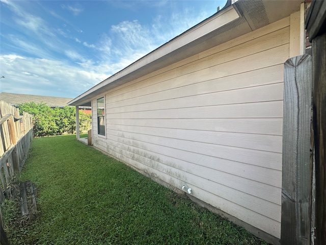 view of home's exterior with a yard