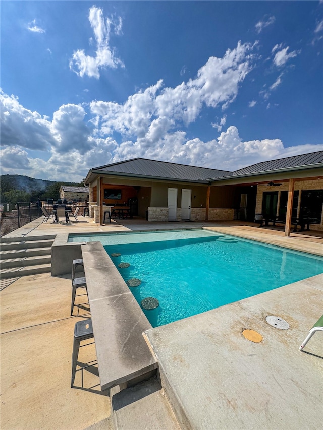 view of pool with a mountain view and a patio