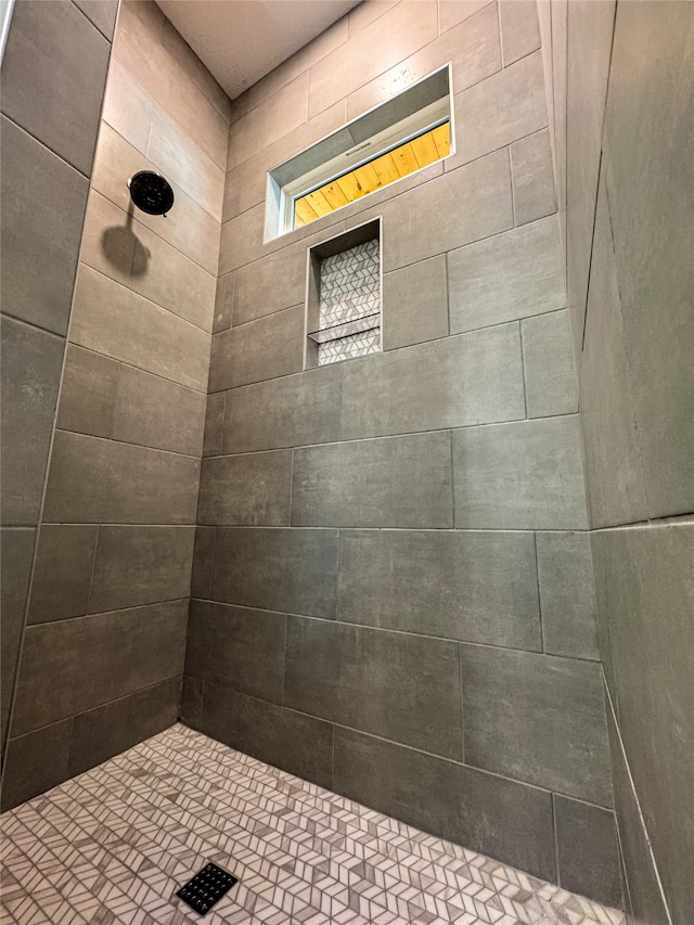 bathroom with tiled shower