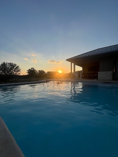 pool at dusk with a water view