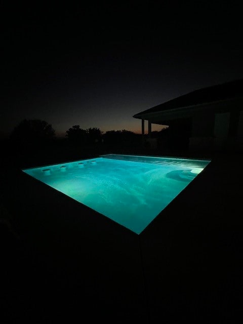 view of pool at night