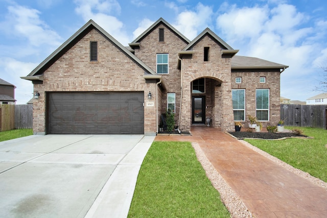 view of front of home featuring a front lawn and a garage