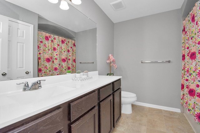 bathroom with vanity, a shower with shower curtain, and toilet