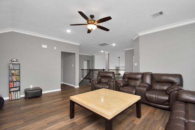 living room featuring dark hardwood / wood-style flooring, vaulted ceiling, ceiling fan, and ornamental molding