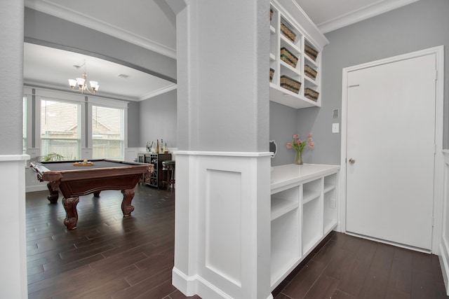 game room featuring a chandelier, ornamental molding, dark wood-type flooring, and billiards