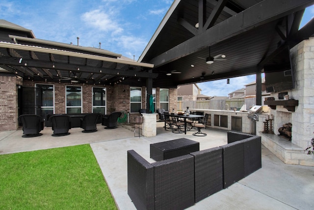 view of patio / terrace featuring an outdoor living space with a fireplace, ceiling fan, a grill, and an outdoor kitchen