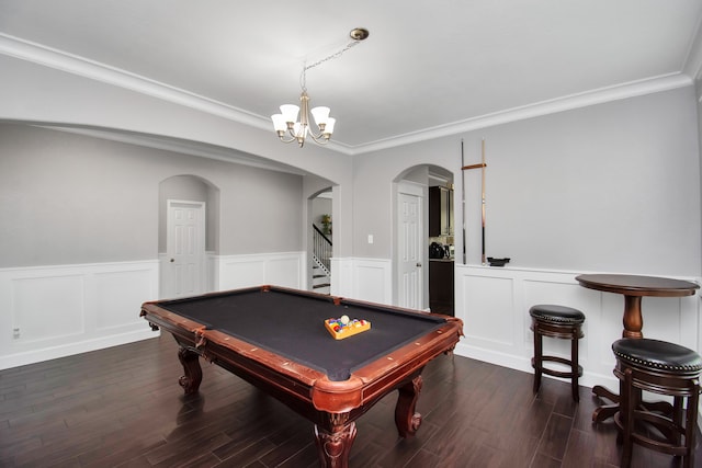 rec room with pool table, an inviting chandelier, dark wood-type flooring, and ornamental molding