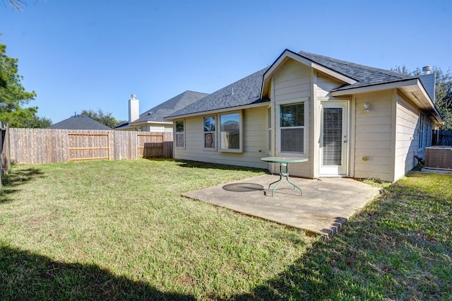 back of property featuring a lawn, a patio area, and central air condition unit