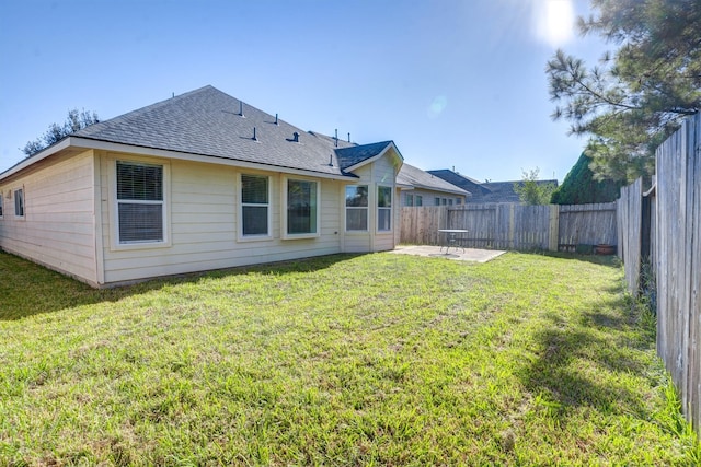 rear view of property with a patio area and a yard