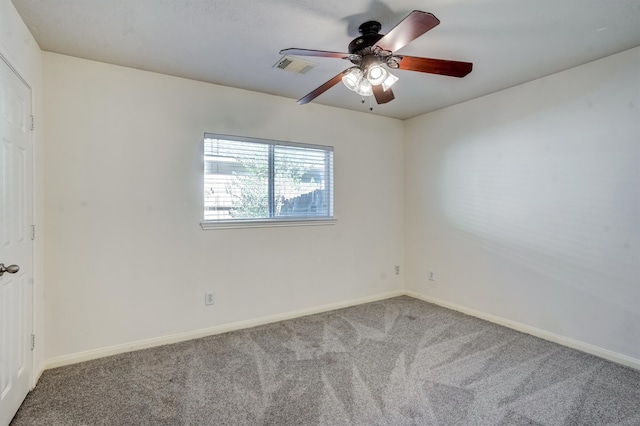 empty room with ceiling fan and carpet